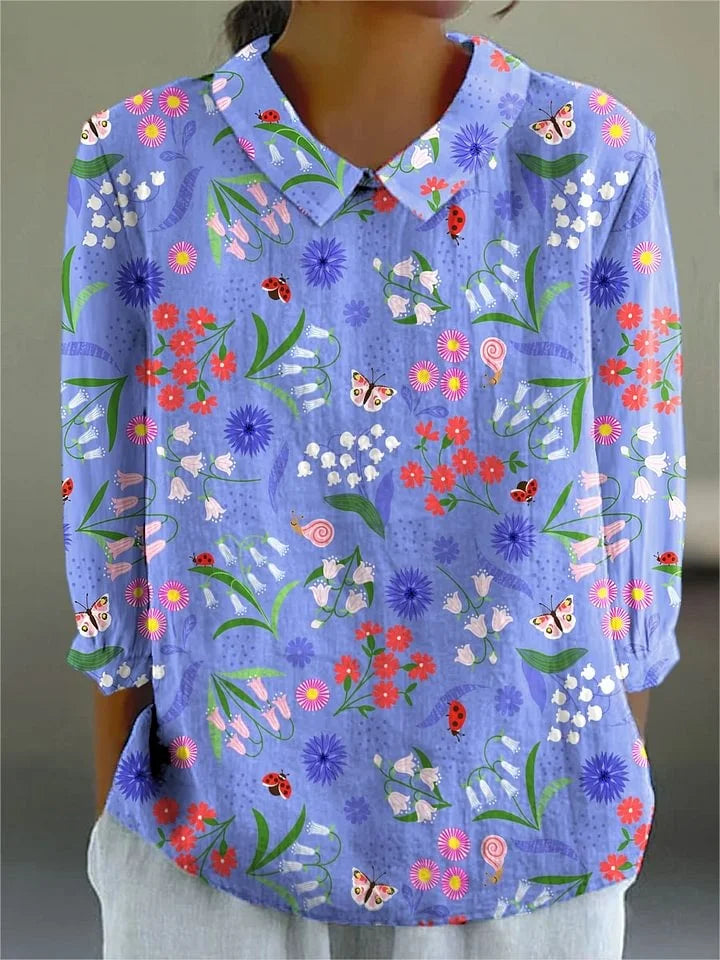 Light blue floral garden button-up blouse with long sleeves, pointed collar, multicolor print