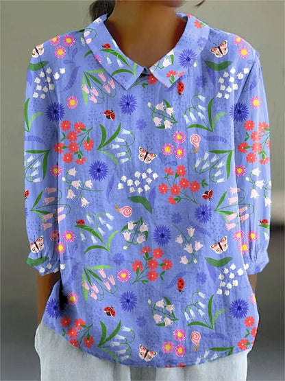 Light blue floral garden button-up blouse with long sleeves, pointed collar, multicolor print