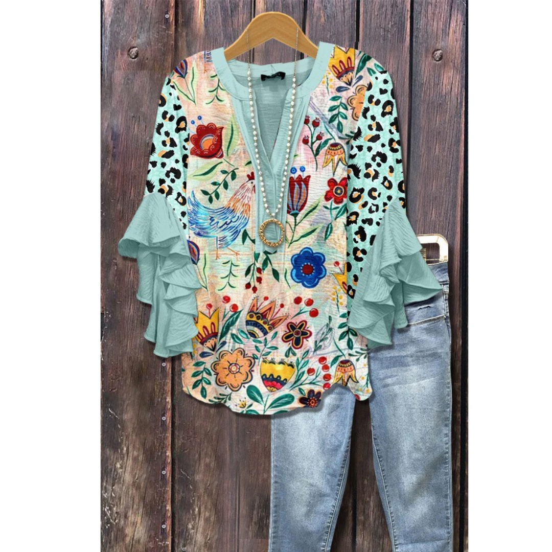 Women’s vintage floral blouse with teal ruffle sleeves and multicolor print
