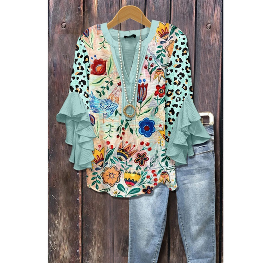 Women’s vintage floral blouse with teal ruffle sleeves and multicolor print