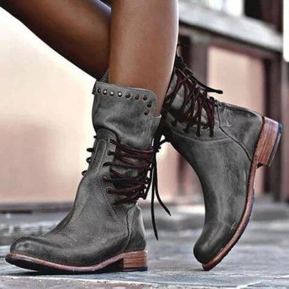 Dark grey leather lace-up boots with studded cuff and contrast brown outsole.