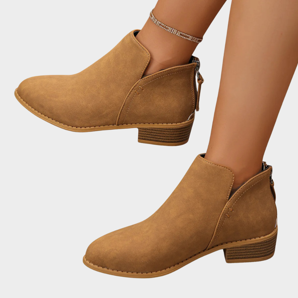 Light brown ankle boots with low block heel and side zipper with pull tab