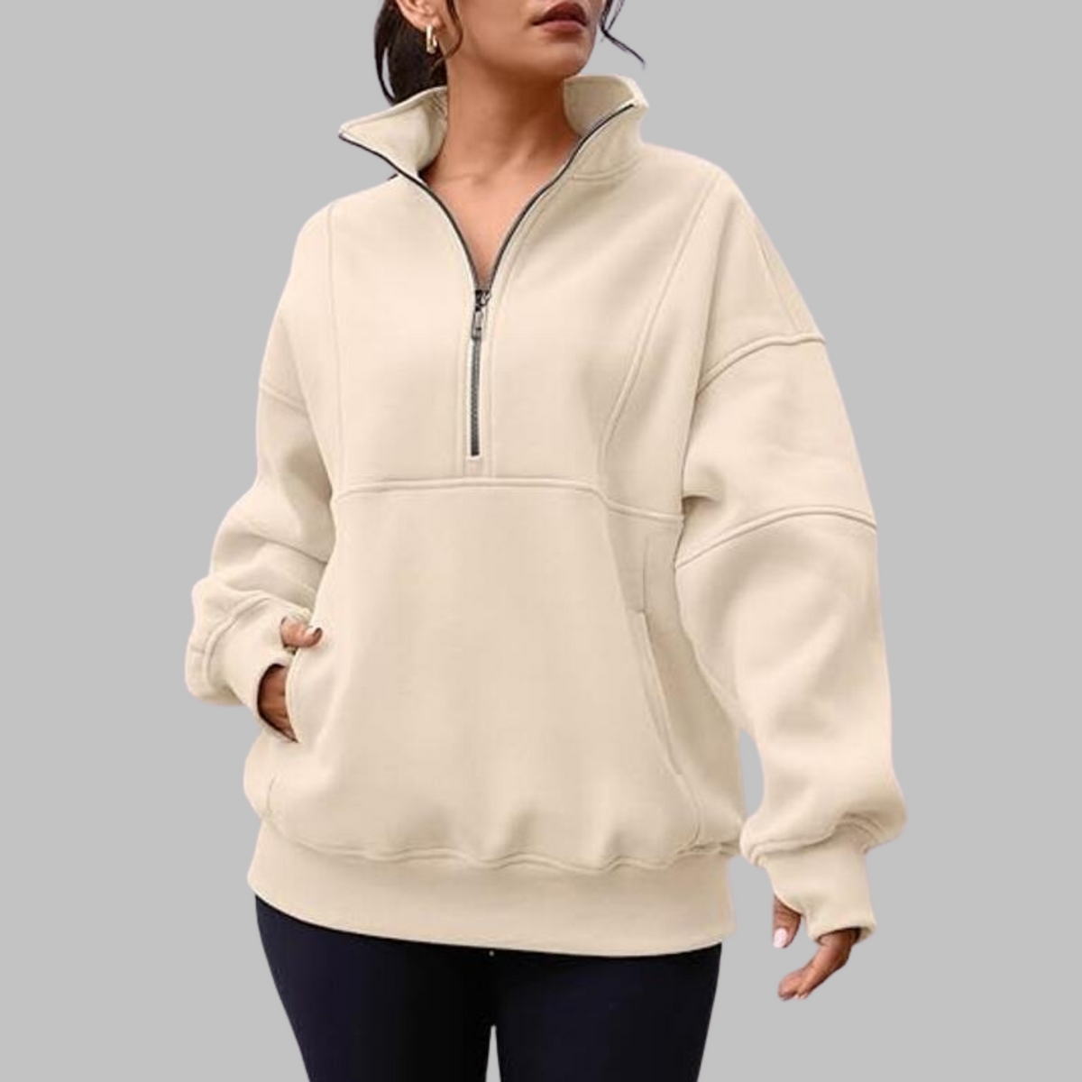 Cream oversized half-zip sweatshirt with stand collar and front zipper, kangaroo pocket