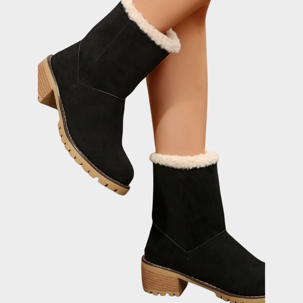 Black suede mid-heel winter boots, side view with white sherpa ankle cuff and tread sole