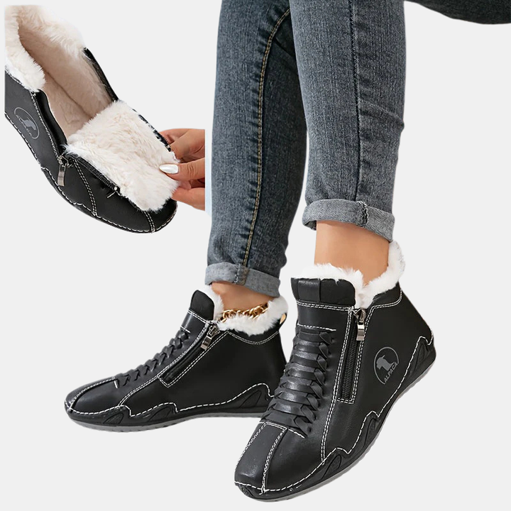 Black ankle boots with faux fur cuff, side zipper, lace-up front, and tan rubber sole.