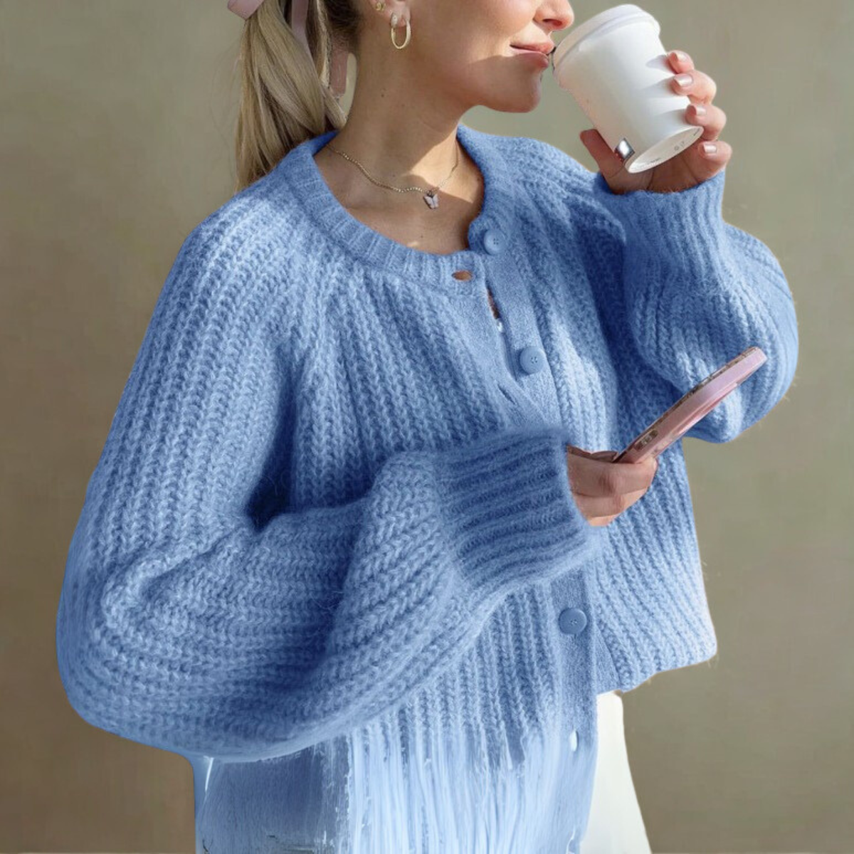 Light blue knit cardigan sweater with round neck, long sleeves, and button-front placket