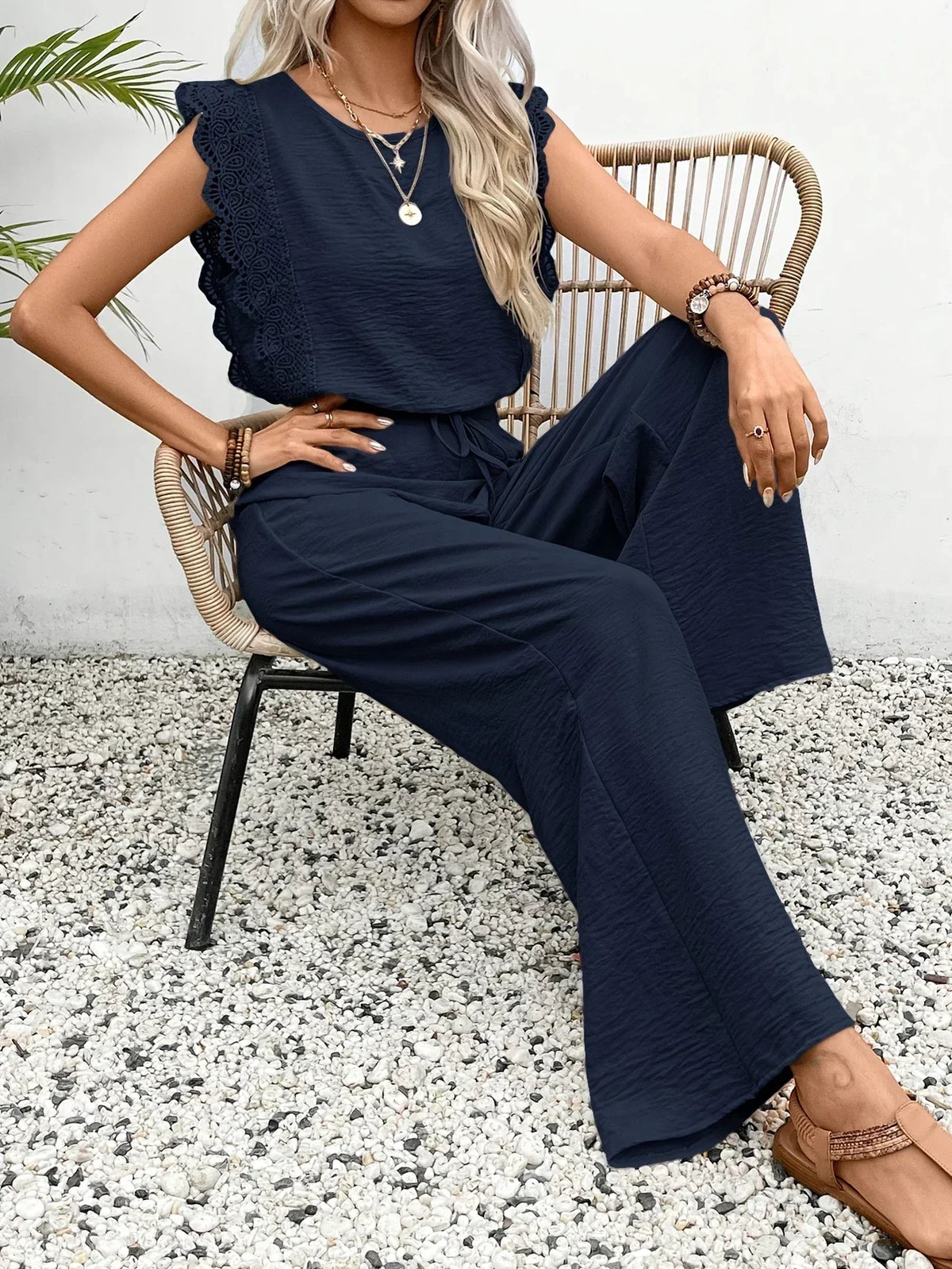 Two-piece set: lace-trim sleeveless top and dark navy wide-leg trousers