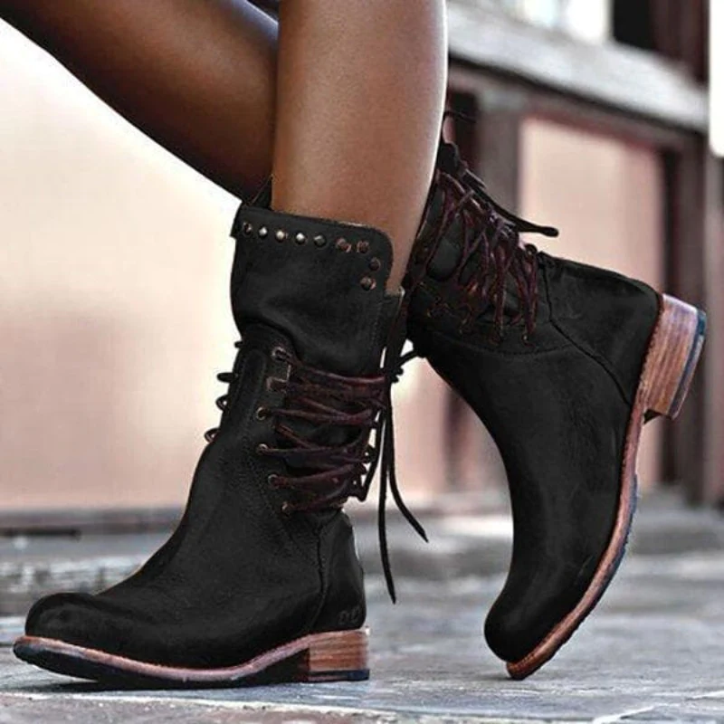 Black leather lace-up boots with studded cuff, rugged outsole, and low block heel.