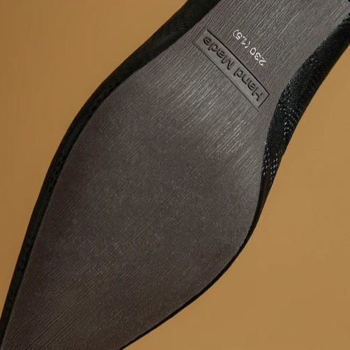 Black insole close-up with printed brand text on the footbed.