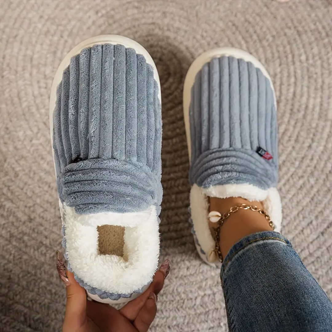 Grey comfort slippers with ribbed fabric uppers and white fuzzy lining at the toe