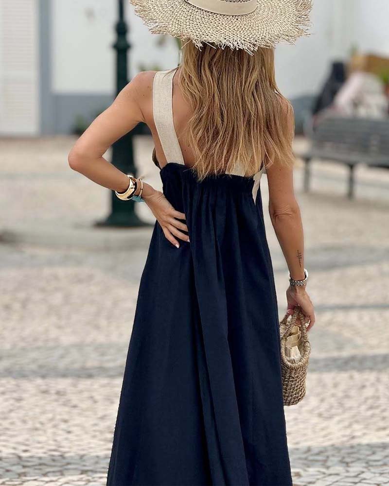 Back view: dark halter maxi dress with open back and crisscross straps