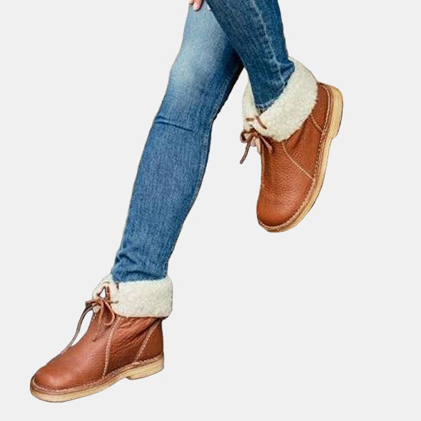 Brown winter boots with cream fur lining, lace-up front and stitched side seams