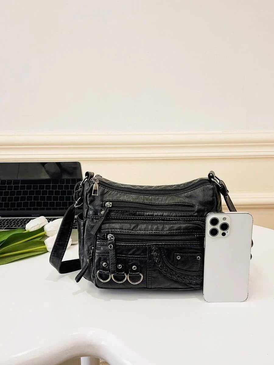 Black multi-pocket crossbody bag with adjustable strap and front zipper compartments