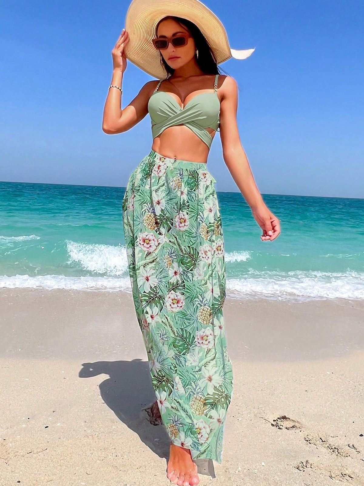 Green bikini top with cross-tie and floral high-waist cover-up skirt set, front view