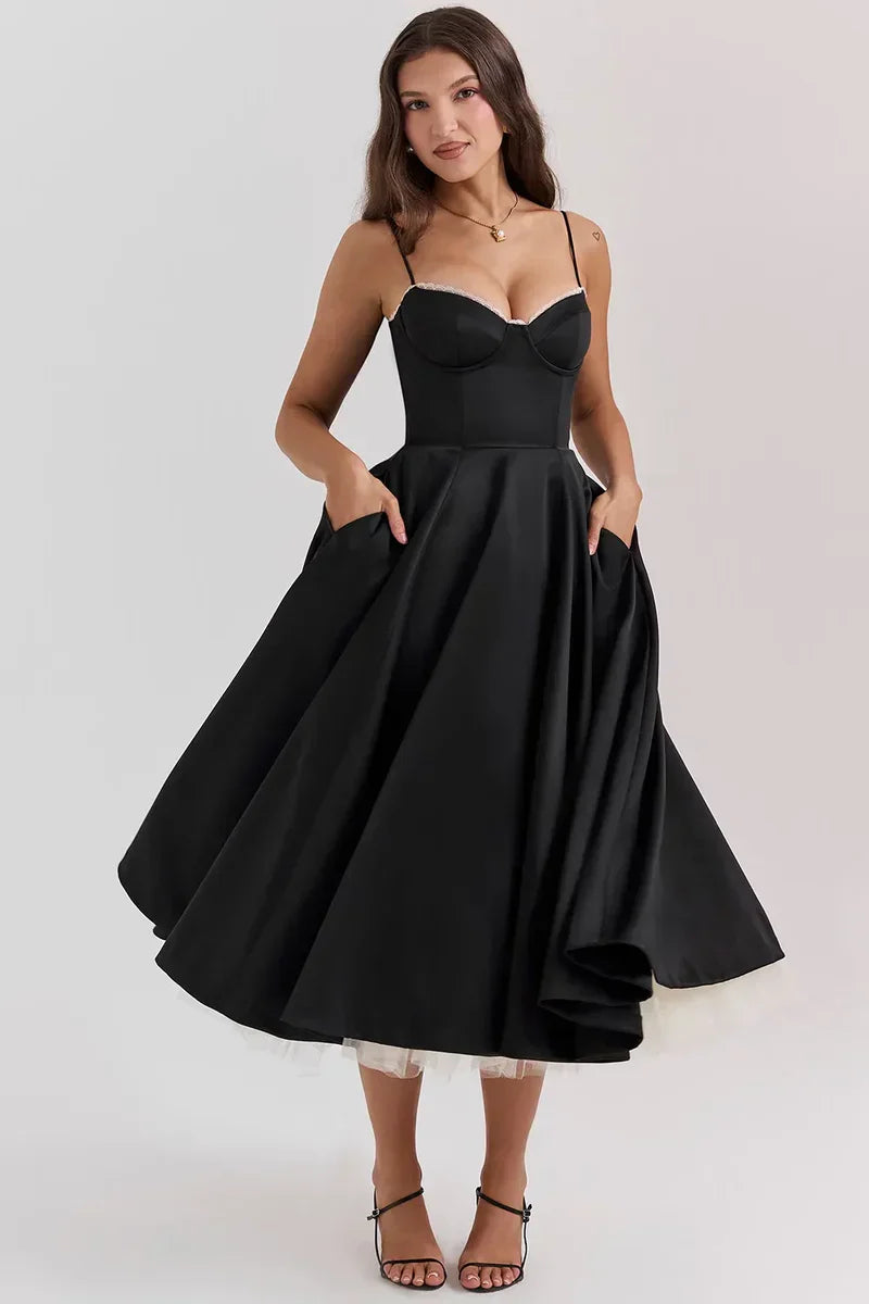 Black satin midi dress with sweetheart neckline, thin straps, and layered tulle underhem