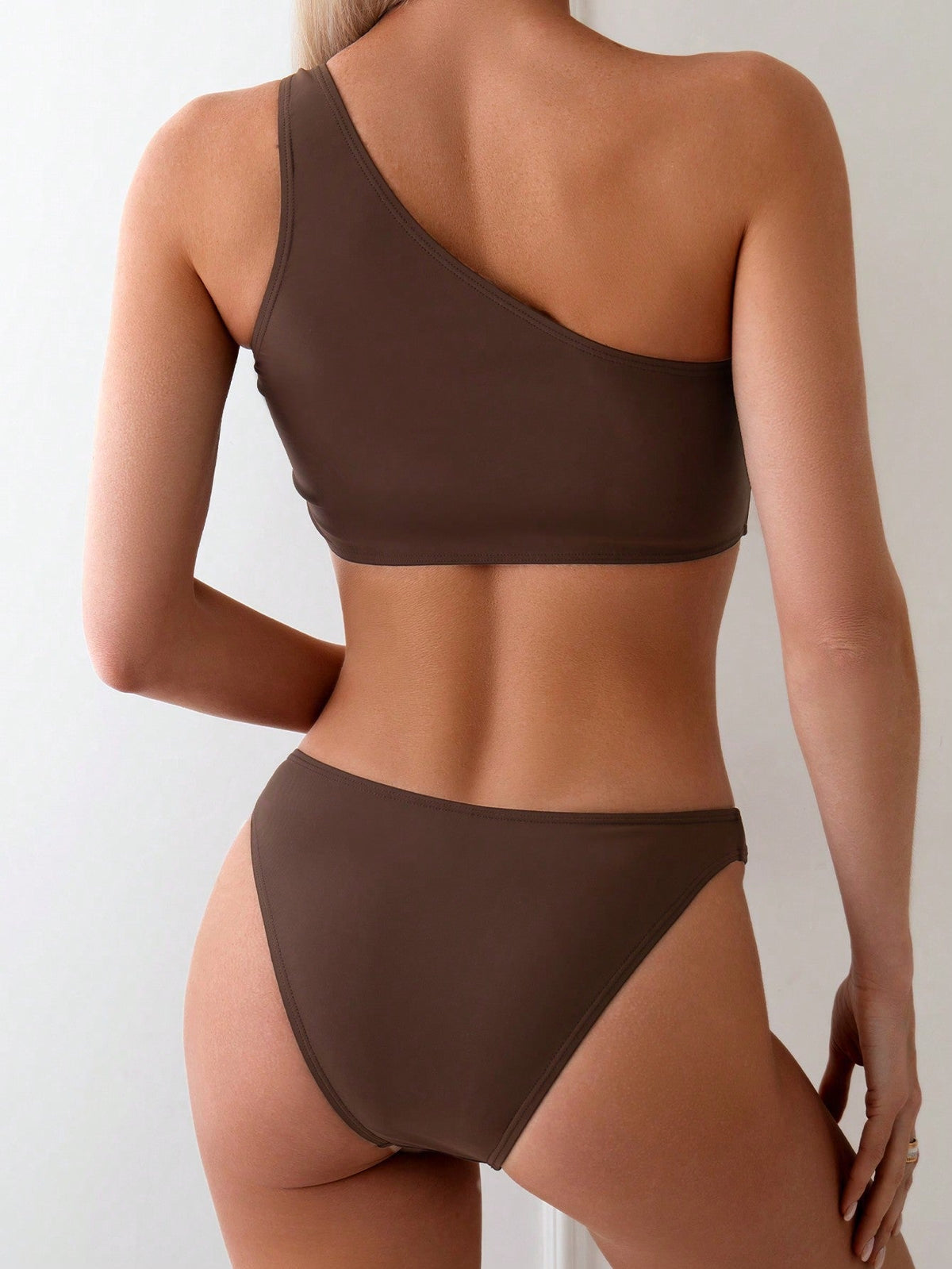 Brown one-shoulder bikini top and matching bikini bottom, back view
