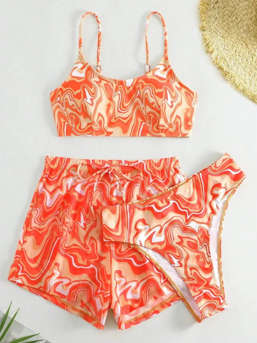 Orange patterned bikini bra top with matching swim shorts set, drawstring waist