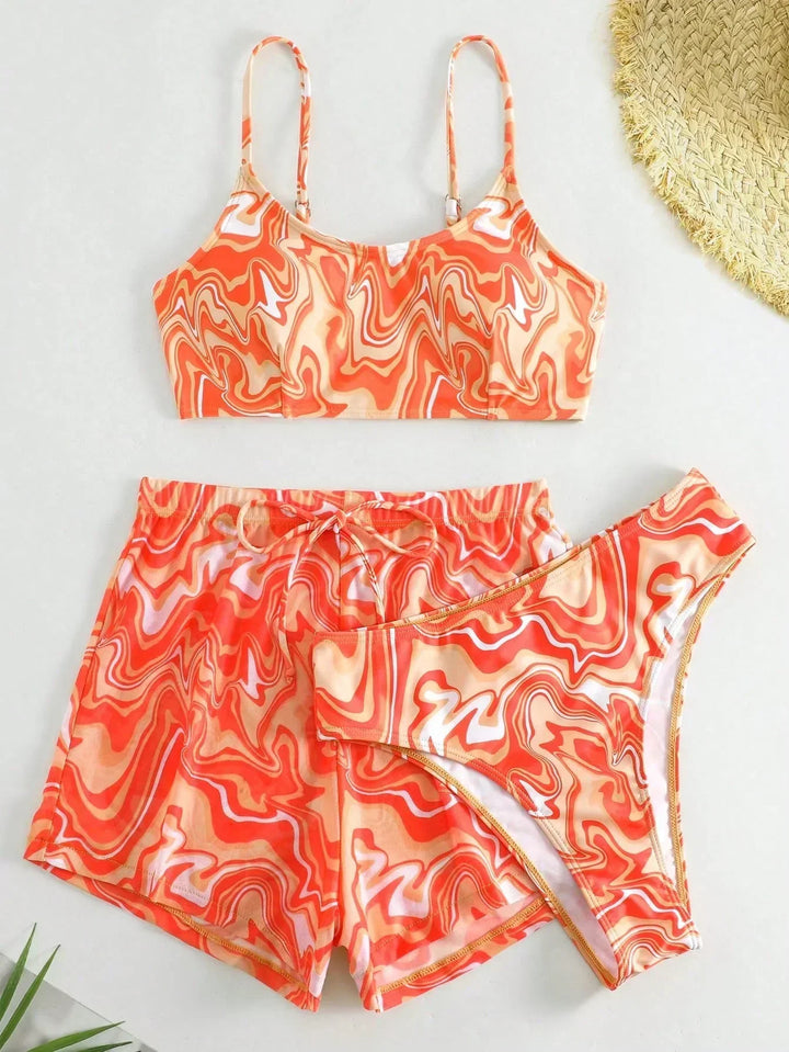 Orange patterned bikini bra top with matching swim shorts set, drawstring waist