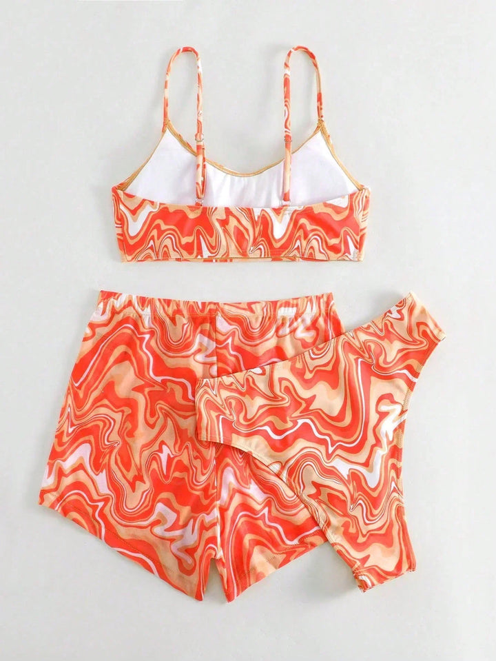 Orange patterned bikini bra top and matching swim shorts set with layered overlap look