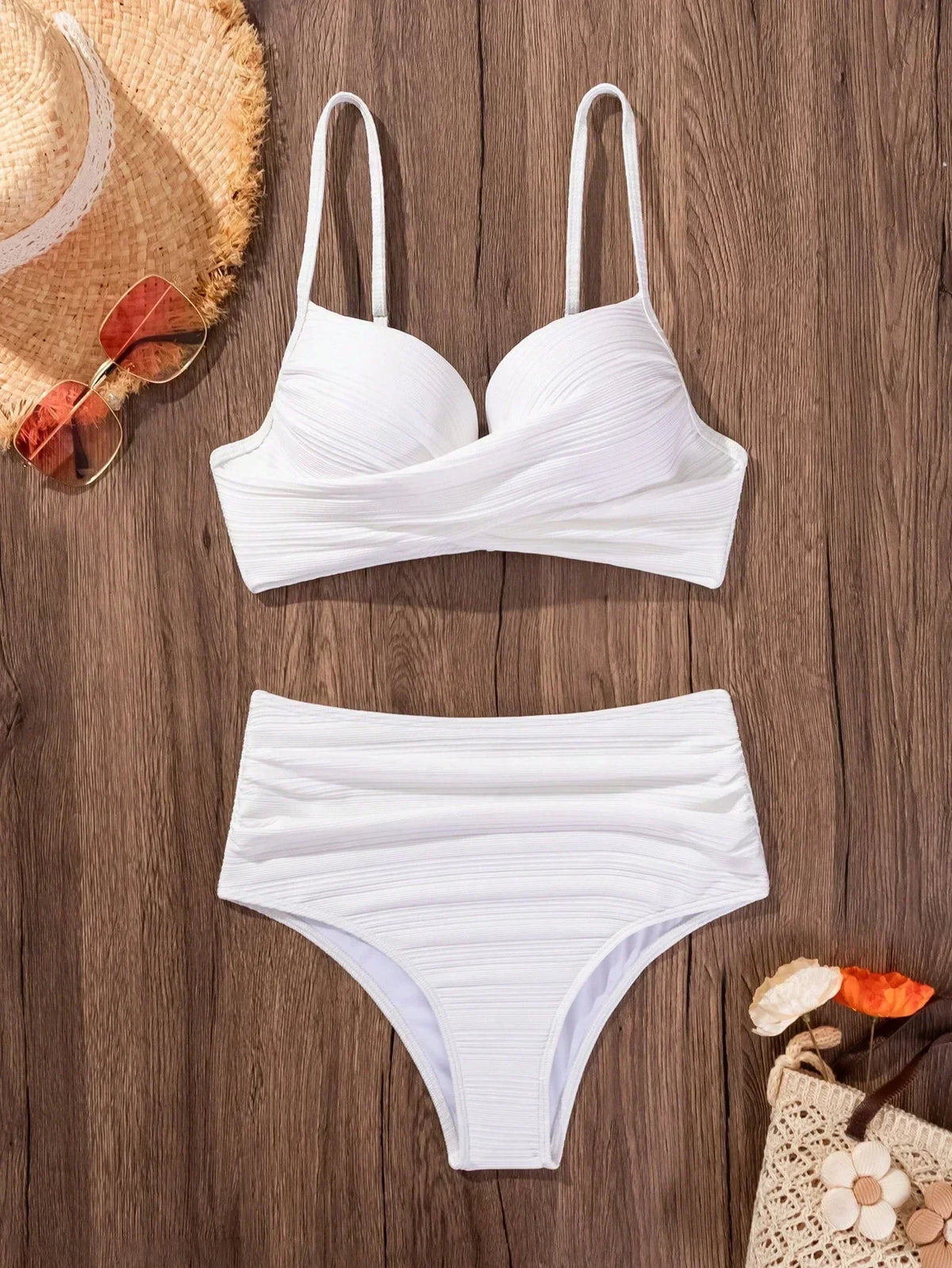 White crossed bikini top and high-waist bikini briefs set, flat lay