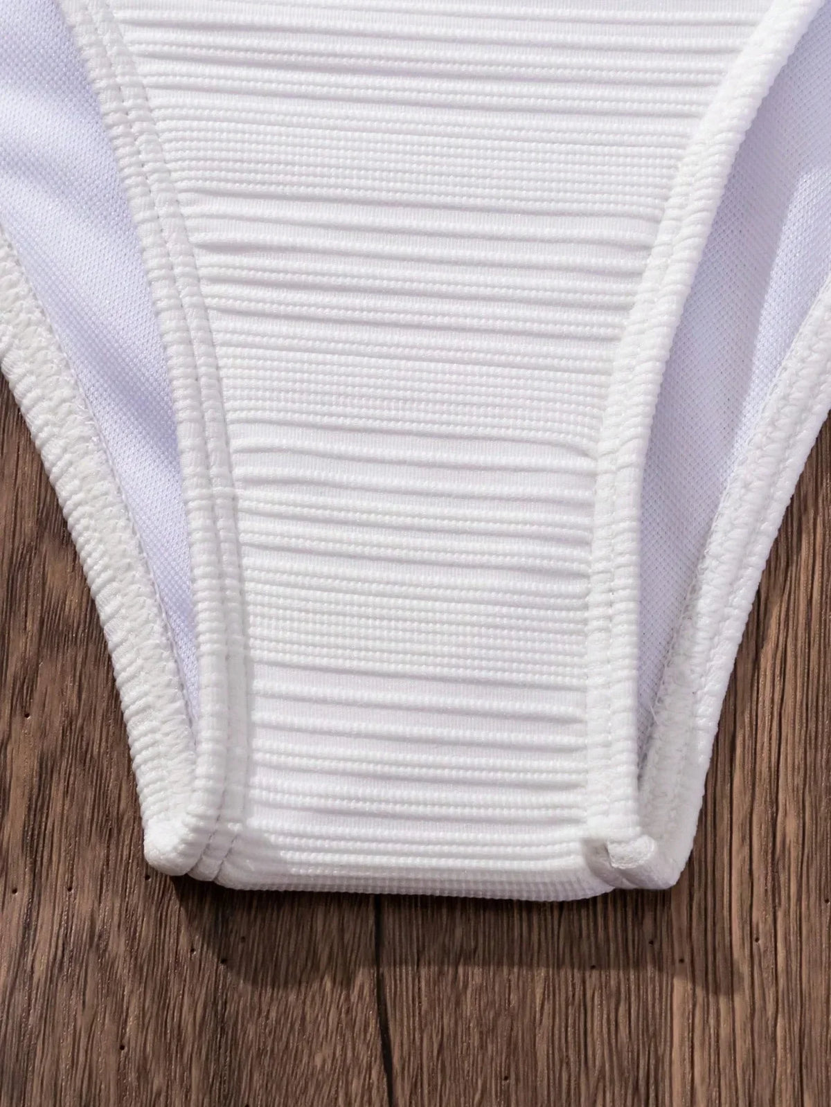 White textured high-waist bikini brief with elastic waistband