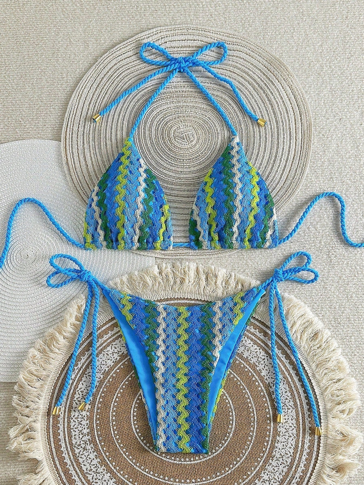 Blue crochet-look triangle bikini with zigzag knit pattern and tie sides