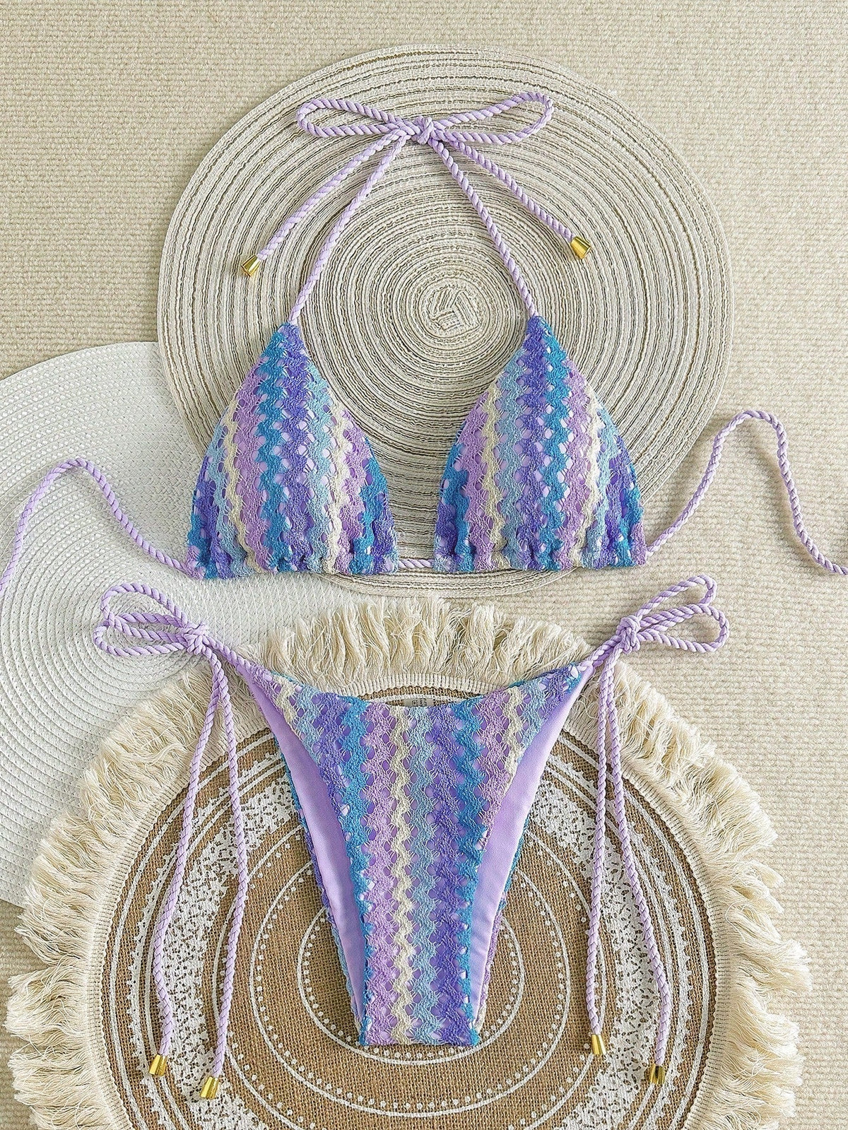 Purple crochet-look triangle bikini with zigzag knit pattern and tie sides