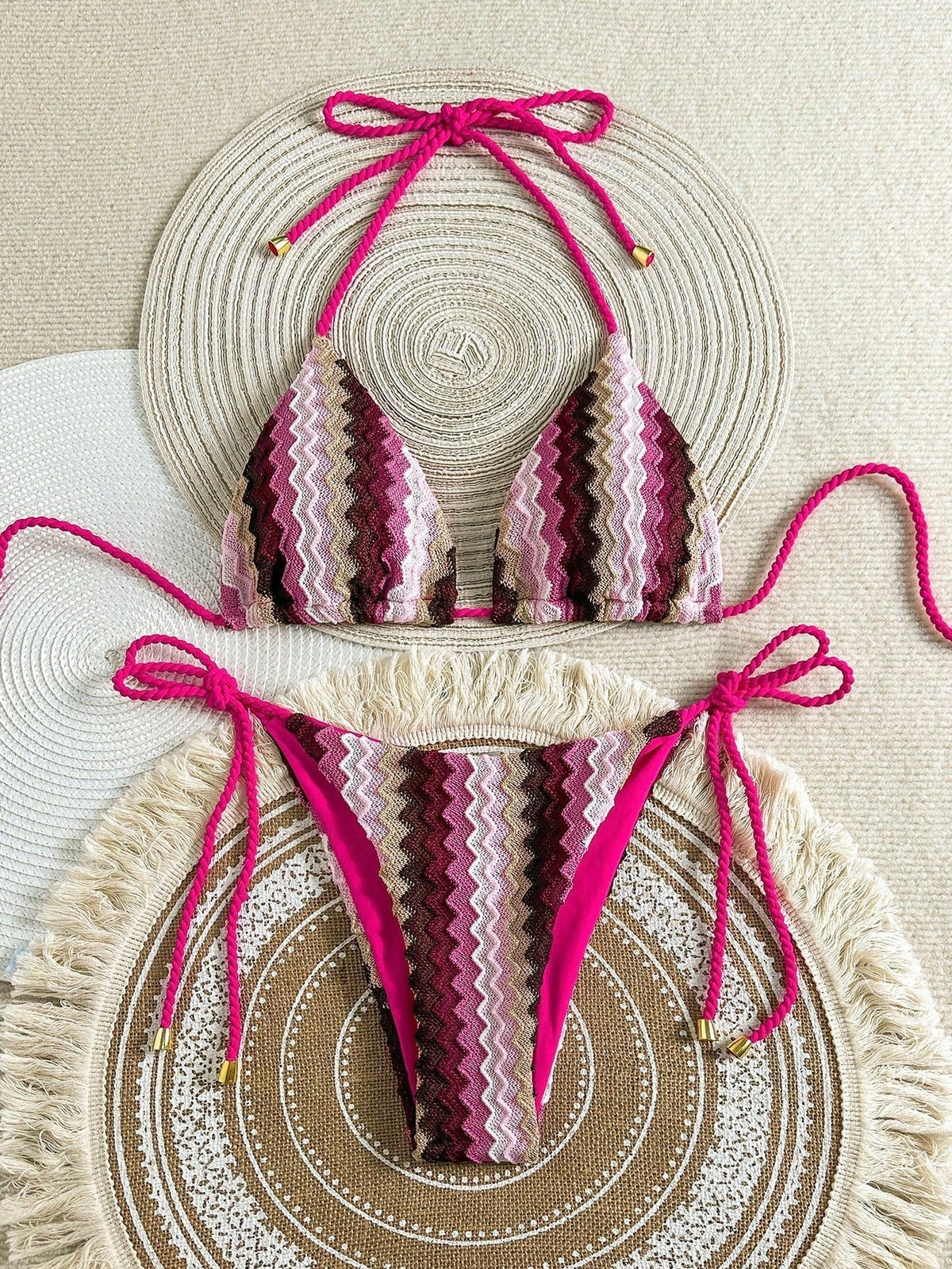 Pink crochet-look triangle bikini with zigzag knit pattern and tie sides