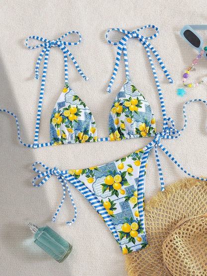 Lemon-print triangle bikini set with blue striped ties, bikini top and bottom laid flat