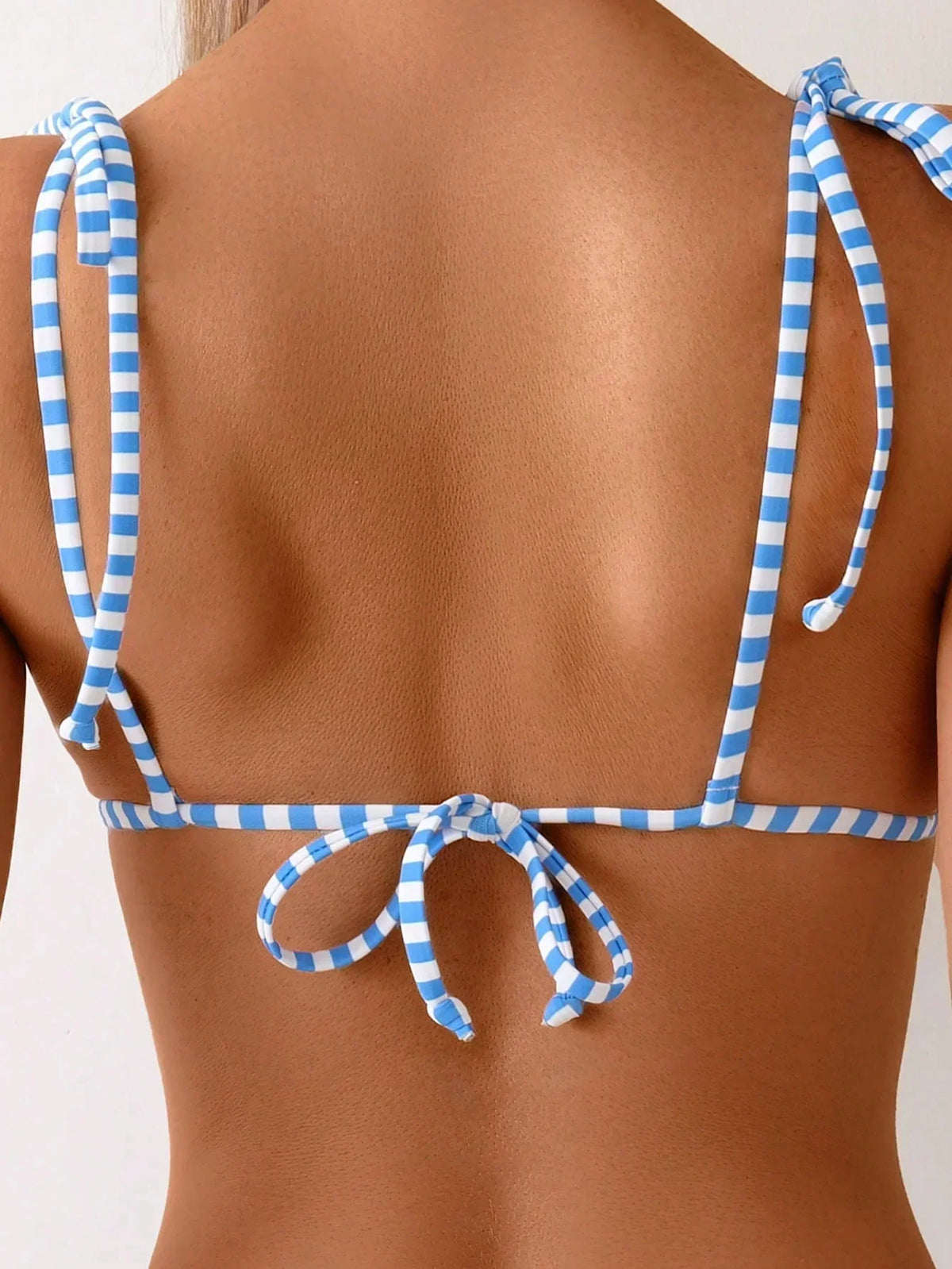Lemon-print triangle bikini back view with blue striped tie bows at neckline and back