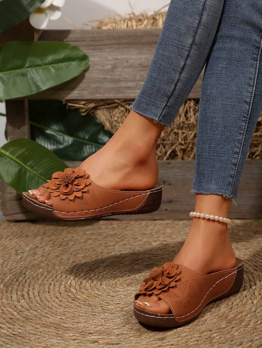 Brown ergonomic sandals with layered flower detail on the front strap, open toe