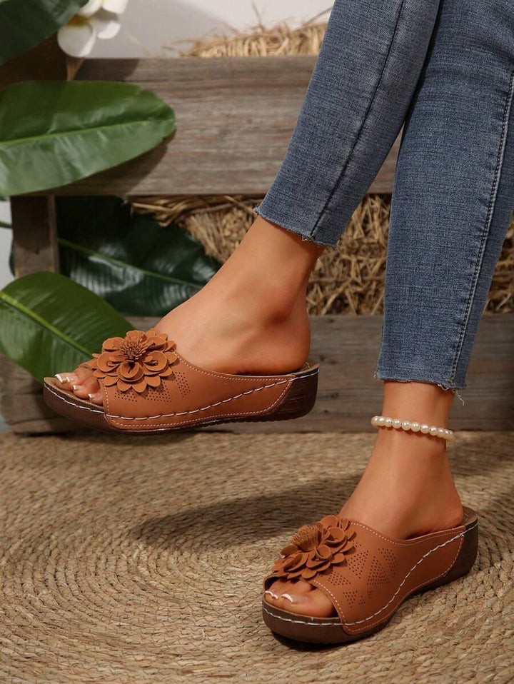 Brown ergonomic sandals with layered flower detail on the front strap, open toe