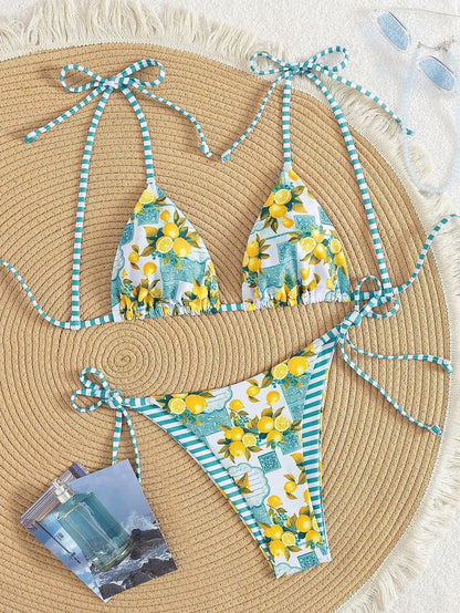 Lemon-print triangle bikini set with blue striped ties, bikini top and bottom laid flat