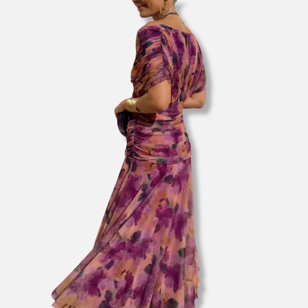 Purple watercolor floral dress with draped off-shoulder neckline and gathered skirt