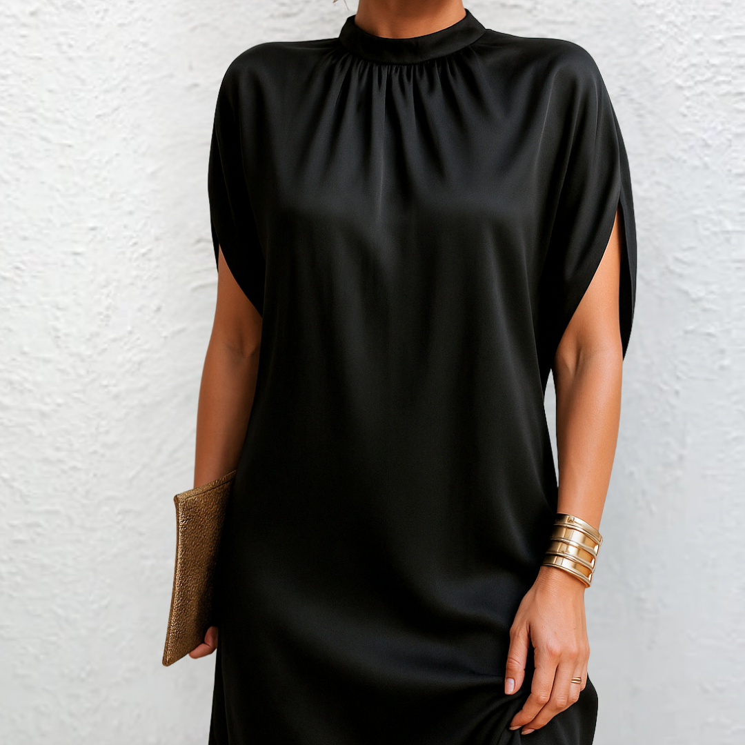 Black mini dress with high neck, gathered yoke, cape sleeves, and side slit