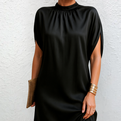 Black mini dress with high neck, gathered yoke, cape sleeves, and side slit