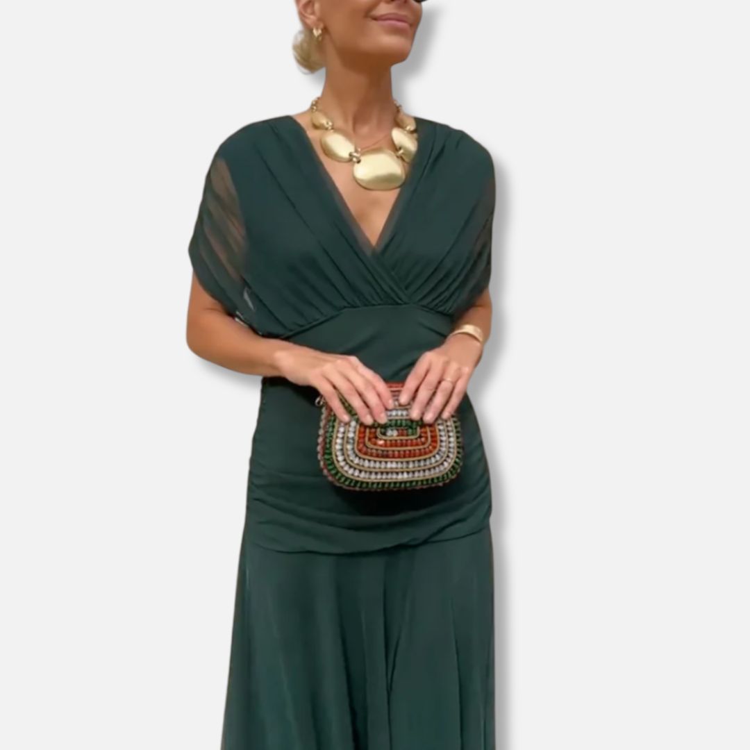 Elegant dress in deep green with V-neckline, draped bodice, and short sleeves