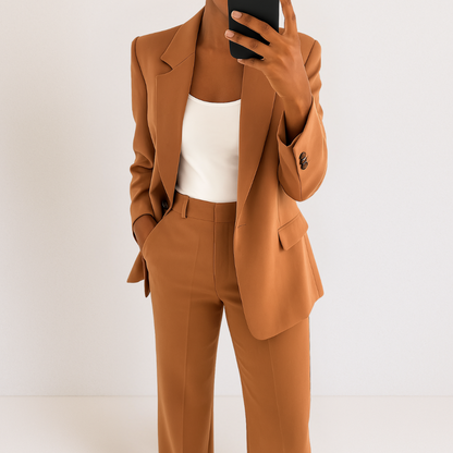 Brown two-piece suit set with tailored blazer and matching trousers, notched lapel and flap pockets.