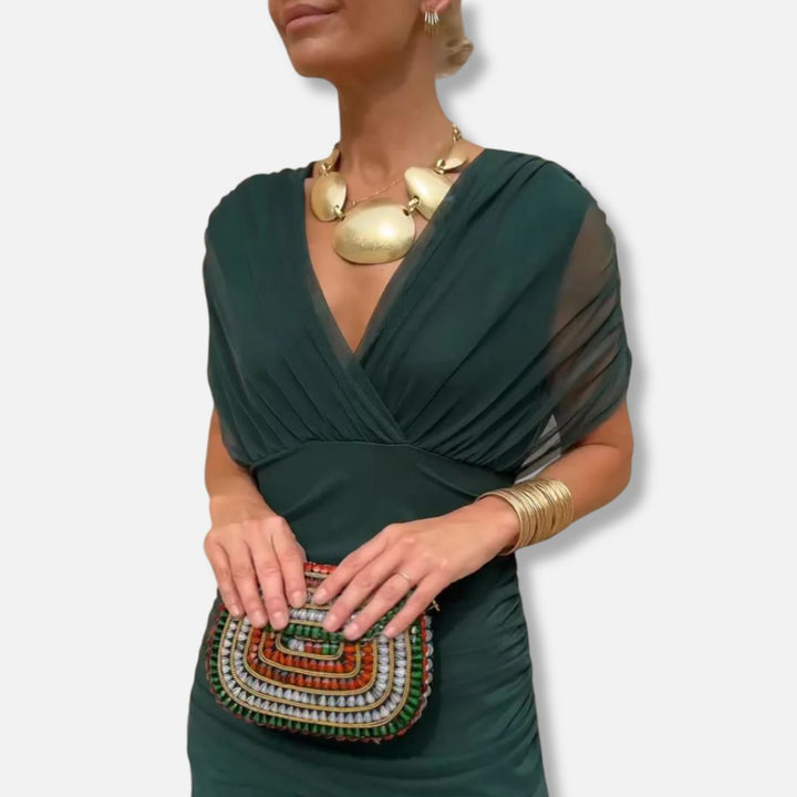 Elegant dress in deep green with V-neckline and draped waist detail