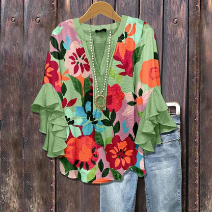 Floral print ruffle sleeve top with V-neck and pearl trim, green base and multicolor flowers