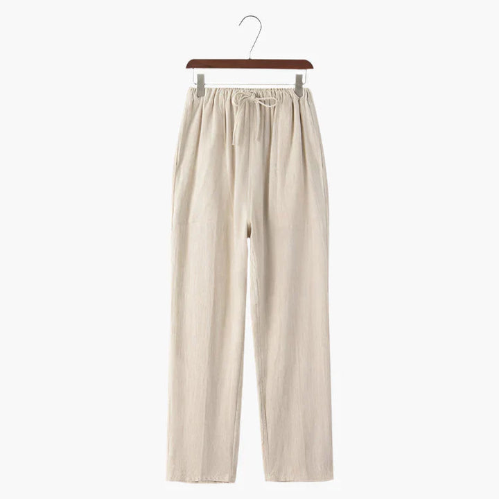Beige linen pants on hanger, elastic drawstring waist and straight wide legs