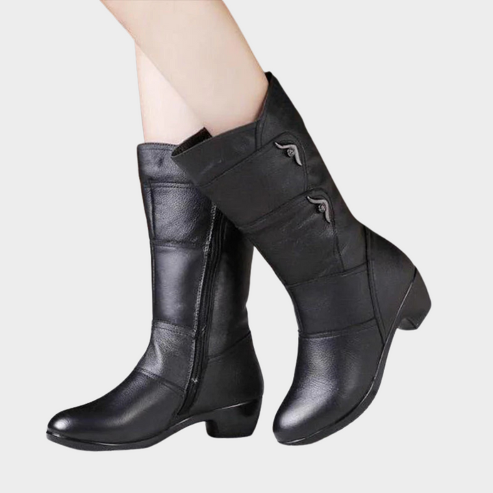 Black leather zip-up ankle boots with side buckle straps and mid block heel