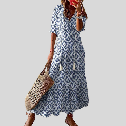 Loose bohemian dress in light blue with blue geometric pattern, short sleeves