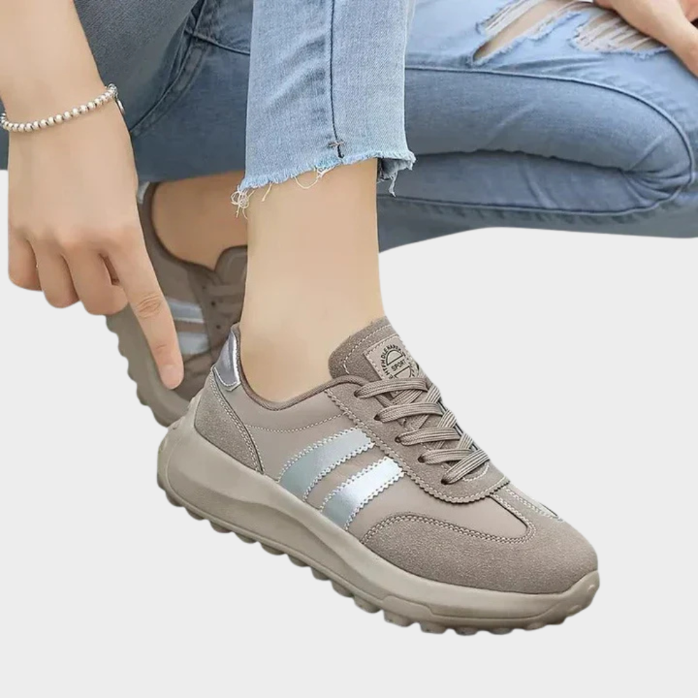 Gray lace-up sneakers with light blue stripes and cushioned outsole in side view