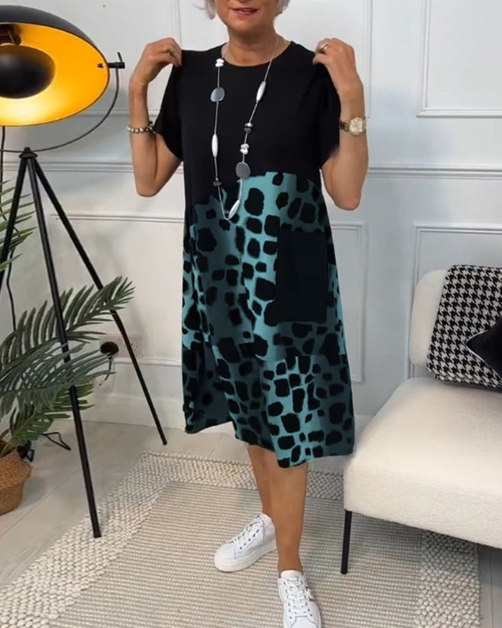 Women's black midi dress with teal leopard print panel, short sleeves, A-line fit