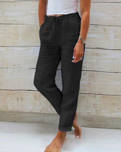 Black drawstring comfort pants with relaxed tapered legs and elastic waistband