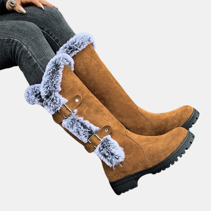 Light brown mid-calf suede boots with light blue faux-fur cuffs, buckle straps, black sole