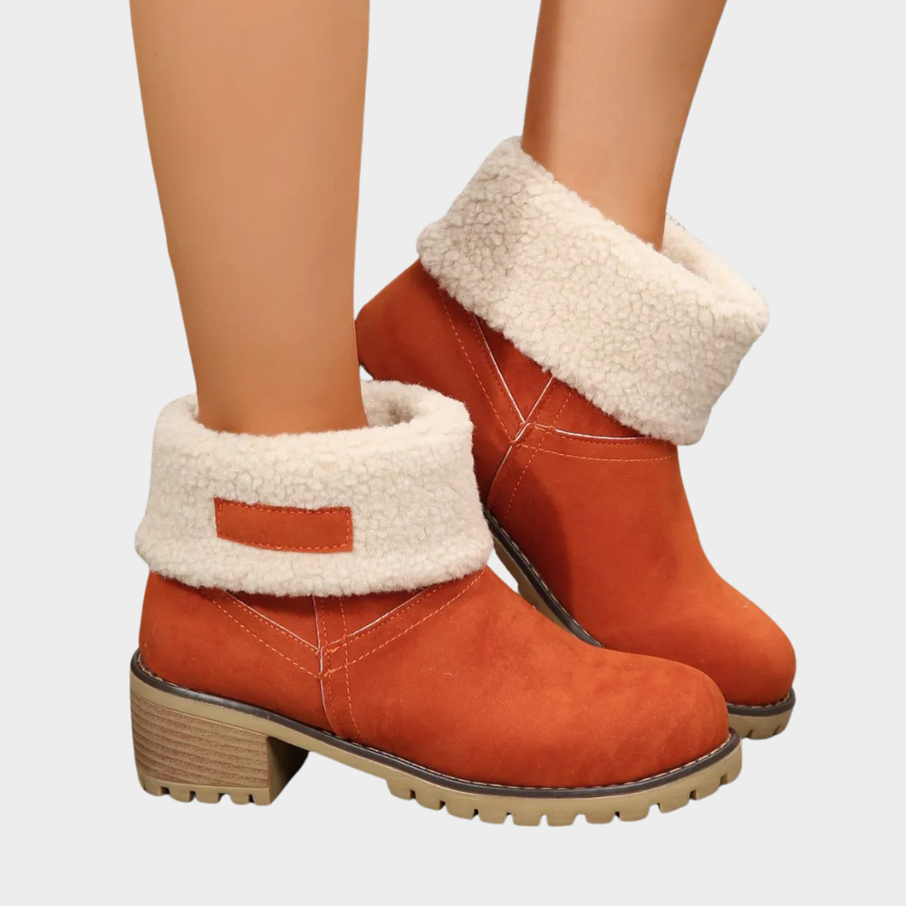 Orange winter ankle boots with thick faux-sherpa cuff, side stitching, and block heel