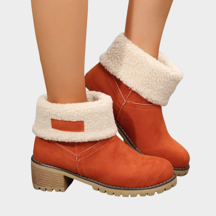 Orange winter ankle boots with thick faux-sherpa cuff, side stitching, and block heel