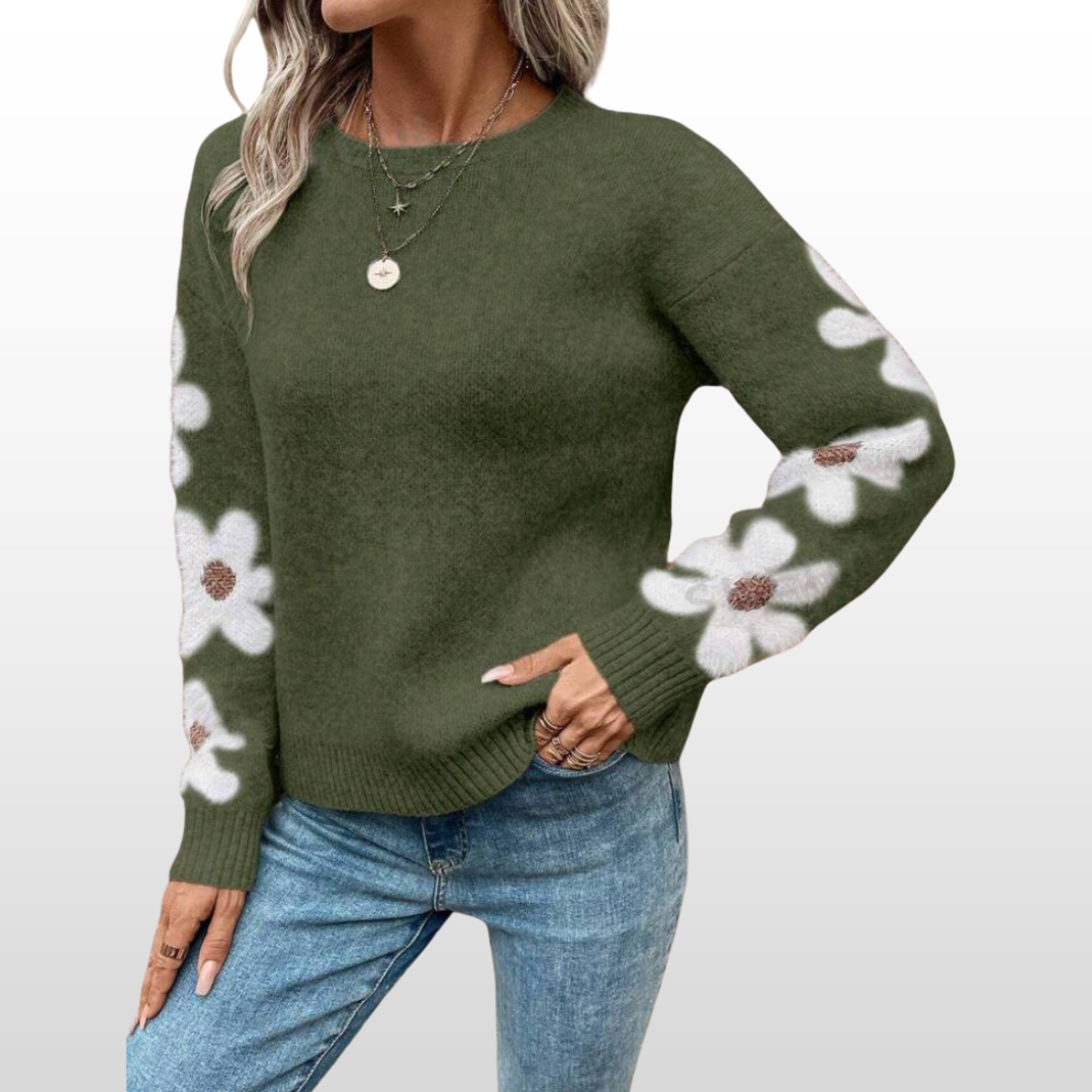 Green round-neck sweater with white floral sleeve pattern and ribbed hem